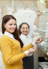 Two women  chooses bridal accessories