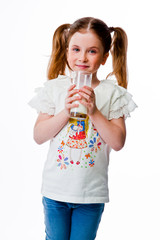 beautiful little girl with a glass of milk