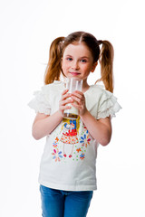 beautiful little girl with a glass of milk