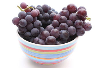 Fresh and natural grapes in a bowl on white background