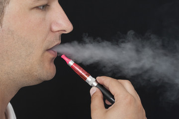 Fototapeta premium Young Man Smokin Electic Cigarette
