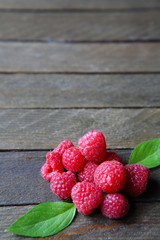 fresh and ripe raspberries on a wooden table
