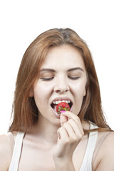 Girl eating a strawberry