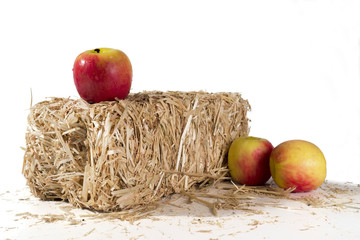 Apples on a bale of hay
