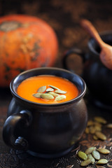 Pumpkin soup with seeds, selective focus