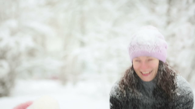 Family playing with snow in winter park