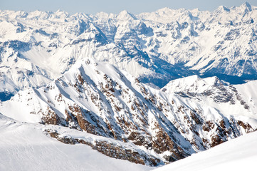 Slopes on a skiing resort in the Alps with mountains background