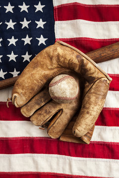 Vintage baseball, bat and glove on American flag