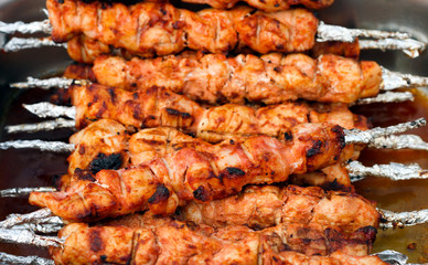 Many roast meat on skewers portions