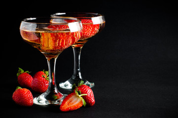 Two glasses of cold champagne with strawberries