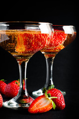 Two glasses of cold champagne with strawberries