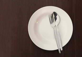 Silverware and plate on table