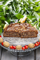 Pieces of nut cake on wooden table.