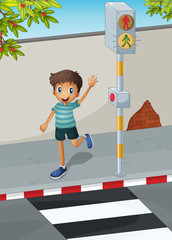 A happy boy waving his hand near the pedestrian lane