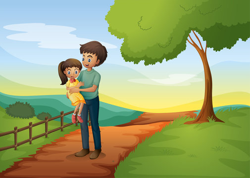 A father carrying his daughter at the hill