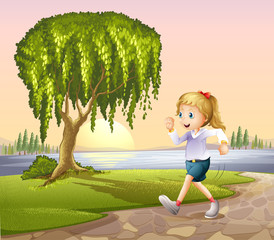 A girl running at the street with a giant tree