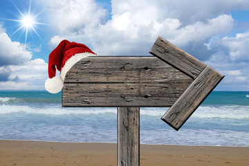 tropical beach wooden signboard with Christmas hat