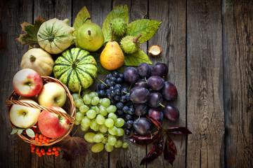 Fruits and vegetables in autumn season on vintage wooden boards