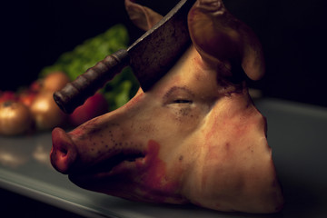 Pig head with a hatchet - 55945231