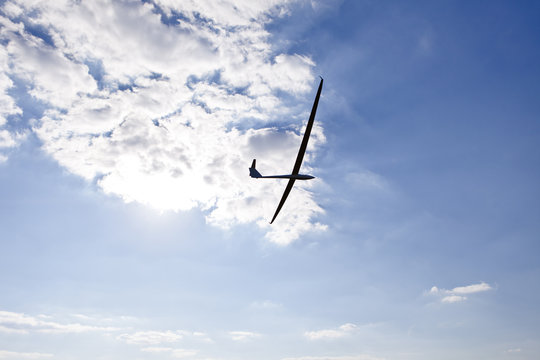 Glider keeping water on the background of the setting sun