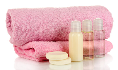 Fototapeta na wymiar Hotel cosmetic bottles with towel isolated on white