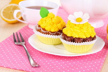 Beautiful lemon cupcakes on dining table close-up