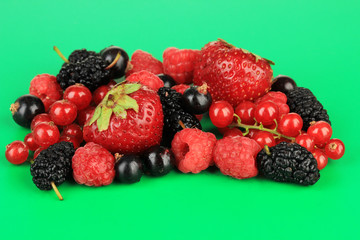 Ripe berries on green background