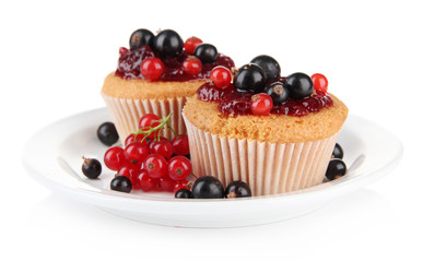 Tasty muffins with berries isolated on white