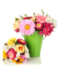 Beautiful bouquet of bright flowers in color vase, isolated
