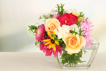 Beautiful bouquet of bright flowers in glass vase,