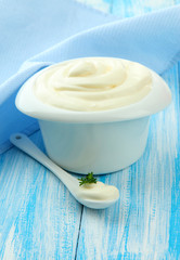 Sour cream in bowl on table close-up