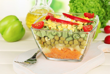 Tasty salad with fresh vegetables on wooden table