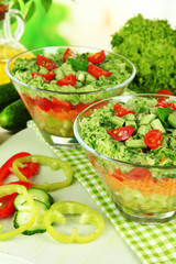 Tasty salad with fresh vegetables on wooden table