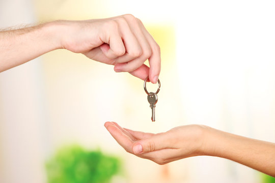 Transfer of house key, on bright background