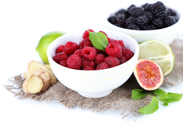 Raspberries and blackberry in small bowls