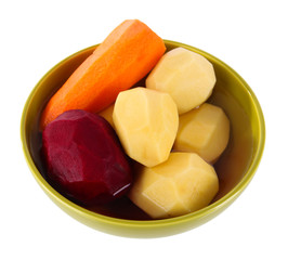 Peeled vegetables in bowl isolated on white