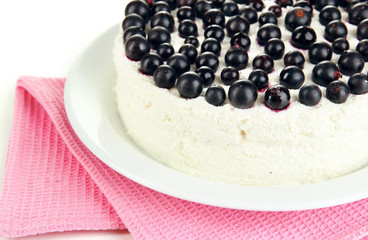 Cheesecake with fresh berries on white plate closeup