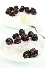 Cheesecake with fresh berries on white plate closeup