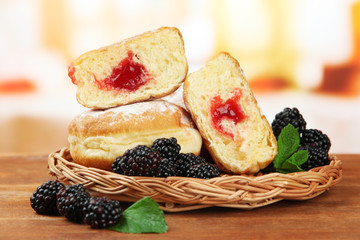 Tasty donuts with berries on wooden table