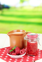 Fresh raspberry, raspberry jam and cream in jug