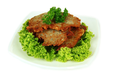 Potato pancakes on plate, isolated on white