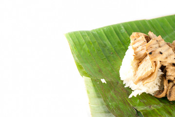 stick rice with pork wrapped in banana leaves