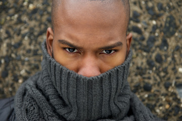 Fashion model with gray winter scarf covering face