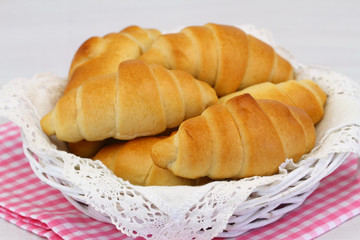 Butter croissants in bread basket, closeup