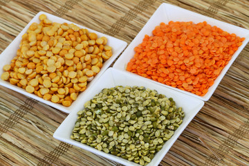 Selection of pulses in white bowls, close up