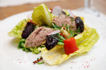 Creative salad with prunes and fish paste