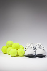 Tennis Concepts: Tennis Sneakers and balls together against whit