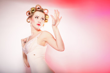 sexy girl in underwear curlers preparing to party