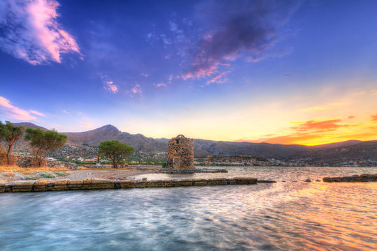Ancient windmill ruin at sunset on Crete, Greece