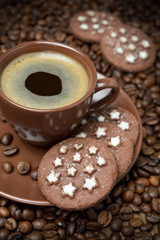 cup of coffee and Christmas cookies on coffee beans background